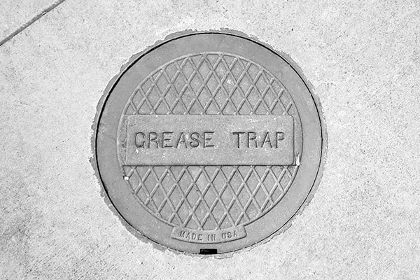 during grease trap pumping, a professional will remove the accumulated grease and solids from the trap using a vacuum truck